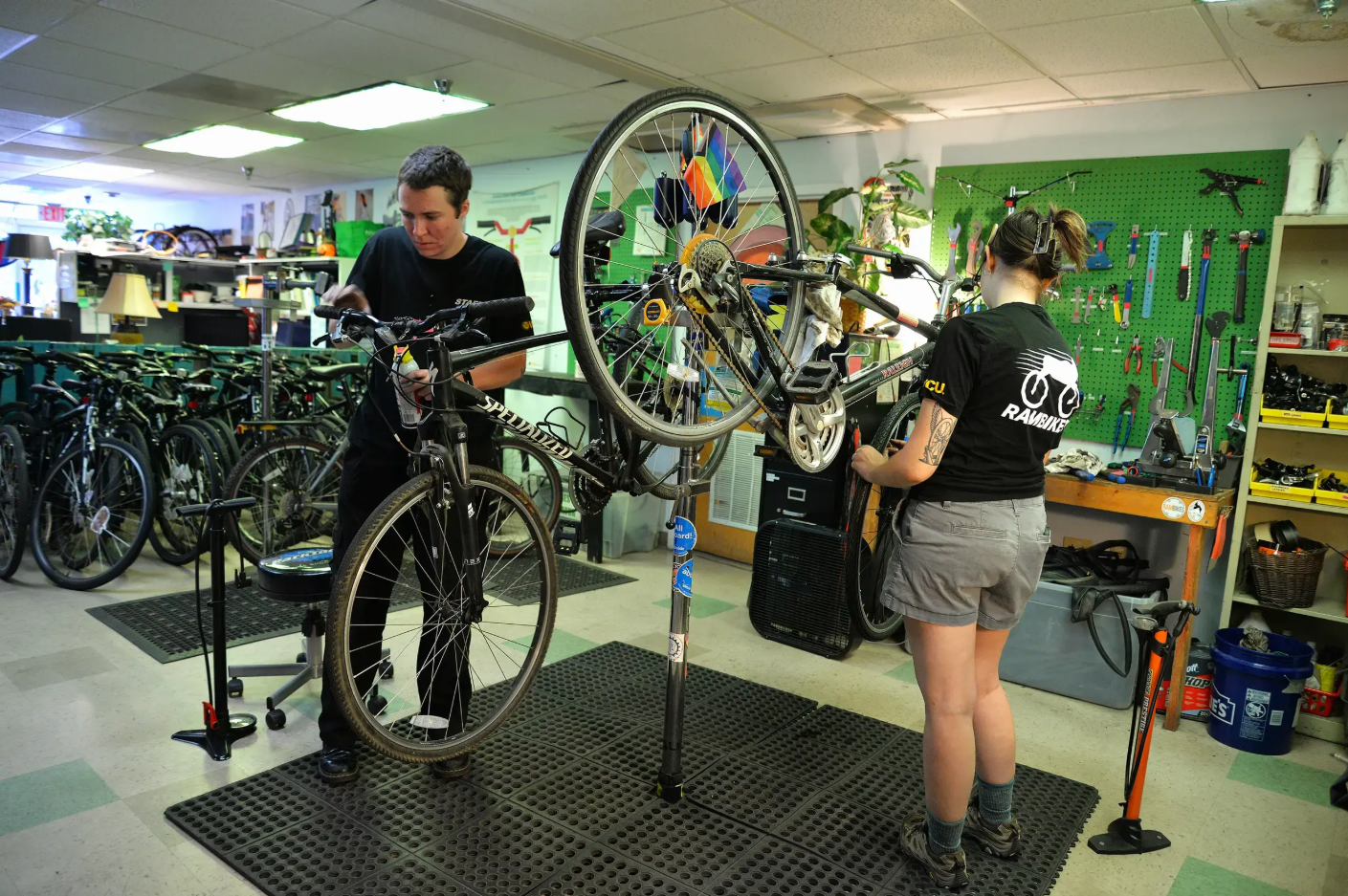 Two mechanics working on bicycles